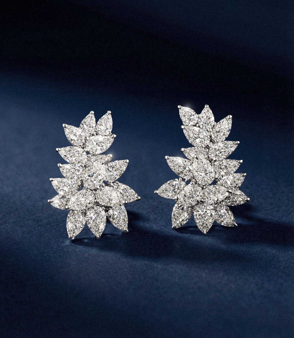 Pair of diamond earrings on a dark blue background